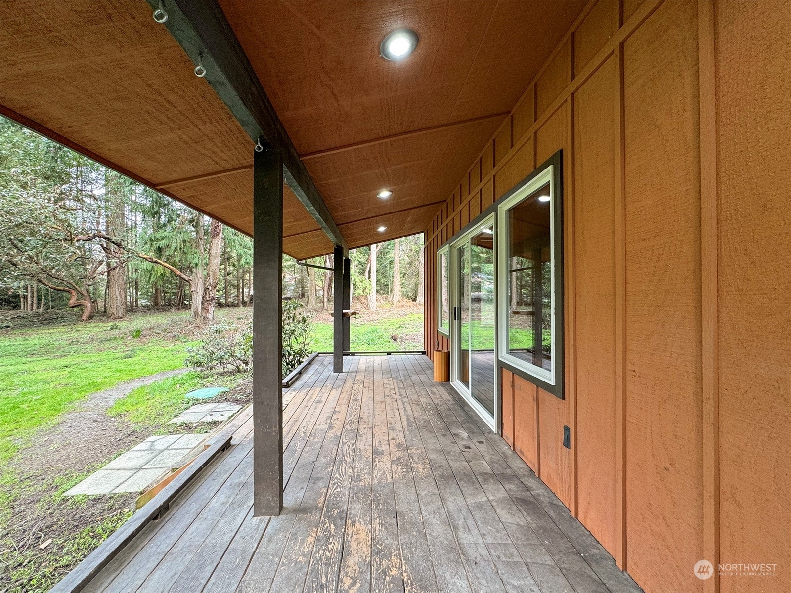253 Sylvan Ridge Road Sequim, WA 98382 - Photo 3 of 40 a view of a porch with wooden floor and outdoor space