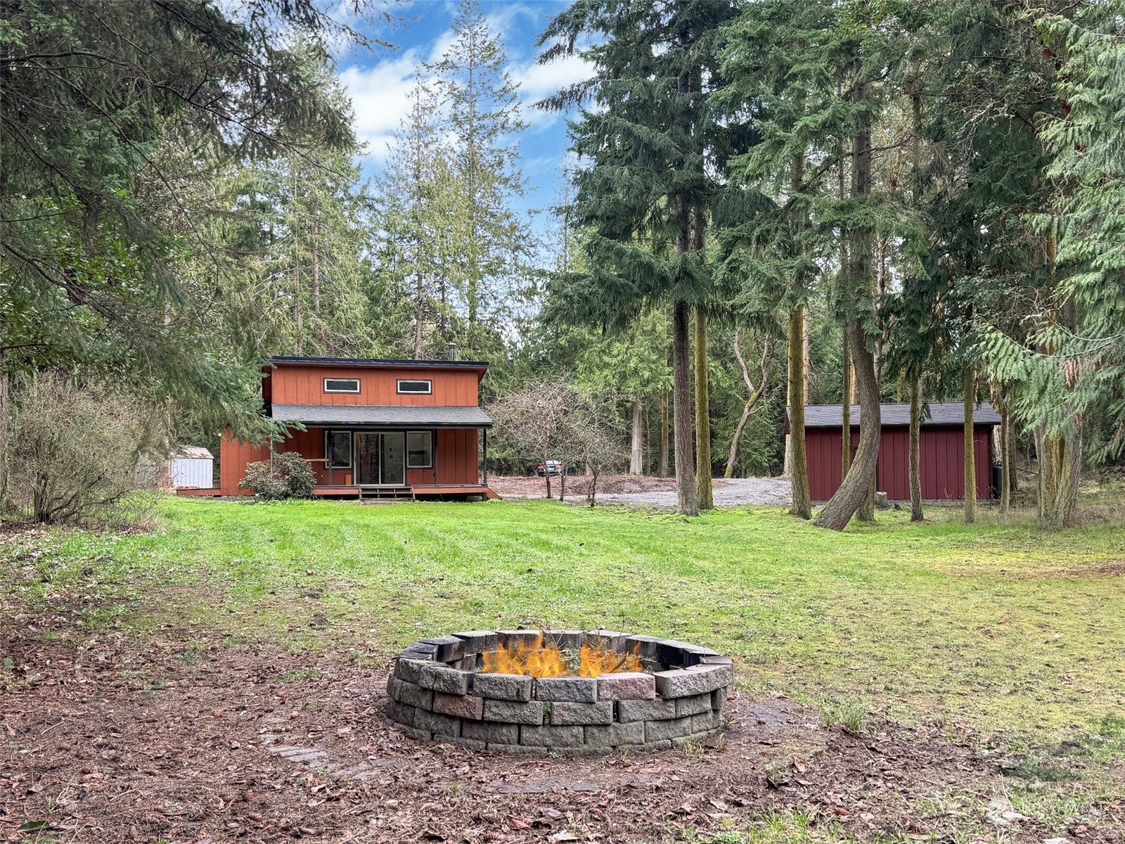 253 Sylvan Ridge Road Sequim, WA 98382 - Photo 33 of 40 a backyard of a house with barbeque oven fire pit and outdoor seating