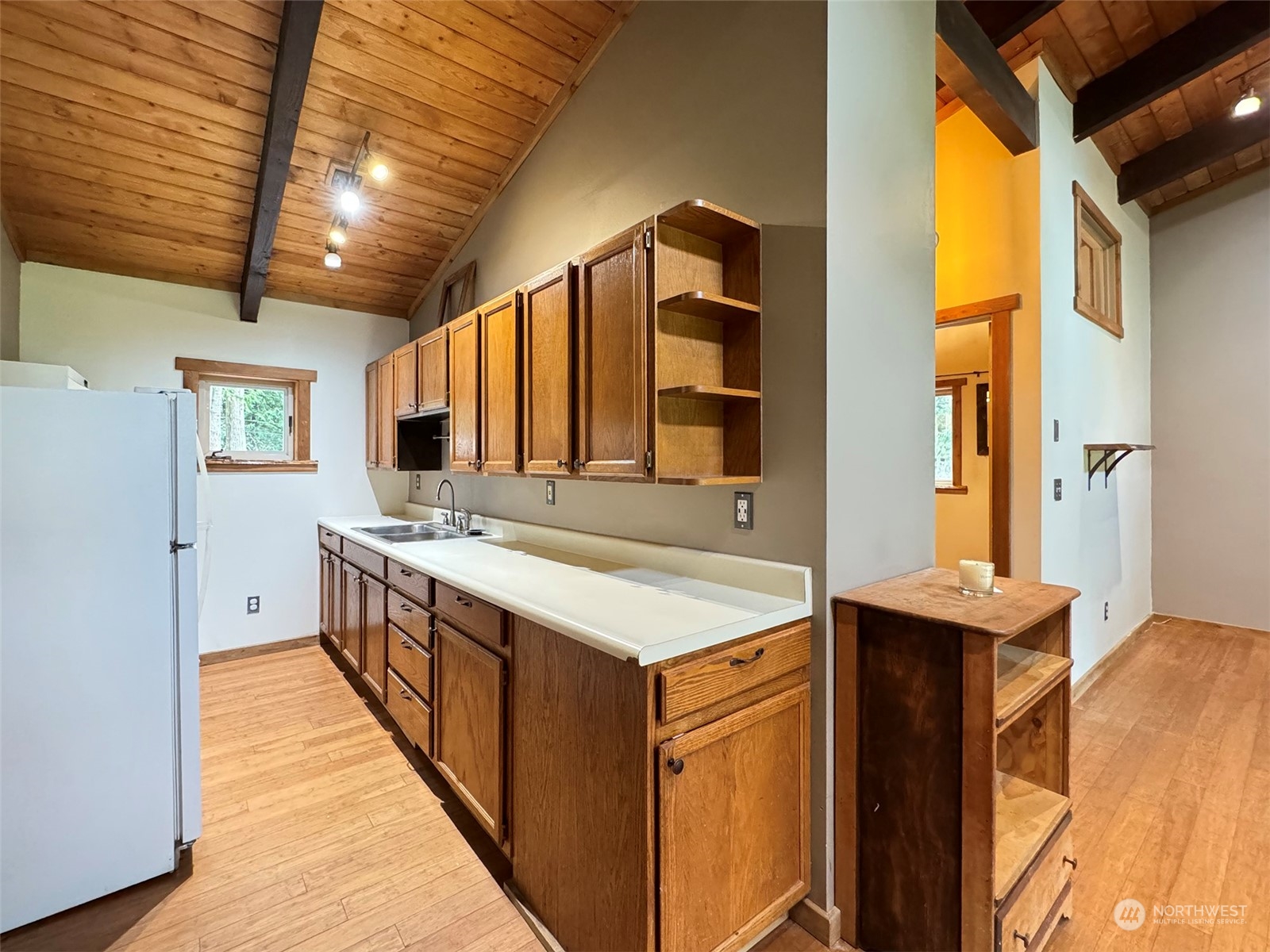 253 Sylvan Ridge Road Sequim, WA 98382 - Photo 8 of 40 a kitchen with a stove and a refrigerator
