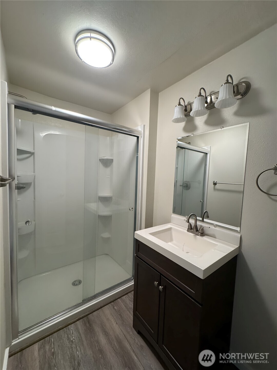201 Union Avenue Southeast, Unit 154 Renton, WA 98059 - Photo 9 of 10 a bathroom with a shower sink and mirror