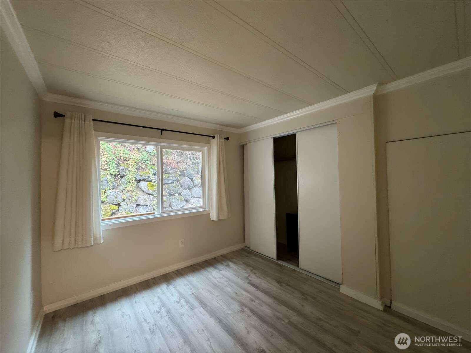 201 Union Avenue Southeast, Unit 154 Renton, WA 98059 - Photo 10 of 10 a view of an empty room with wooden floor and a window