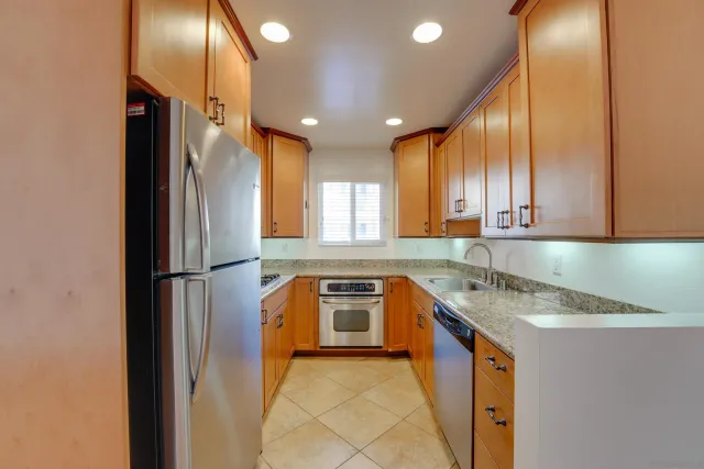 a kitchen with a refrigerator a sink and cabinets