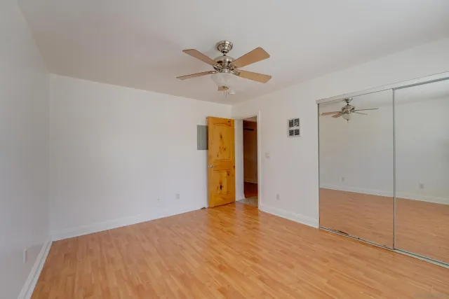 a view of an empty room with closet area