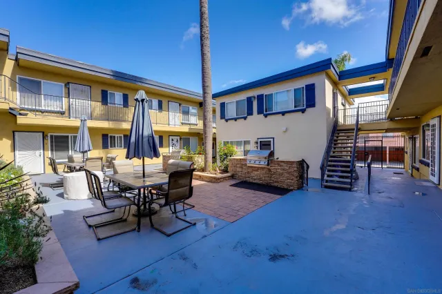 a view of a patio with table and chairs and potted plants