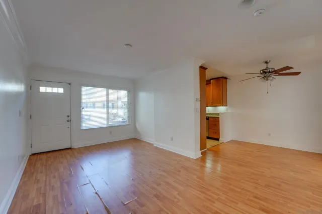 wooden floor in an empty room with a window