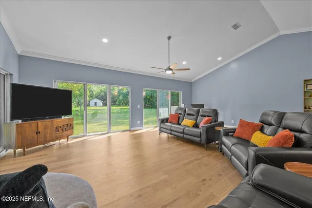 a view of an empty room with a fireplace and a large window