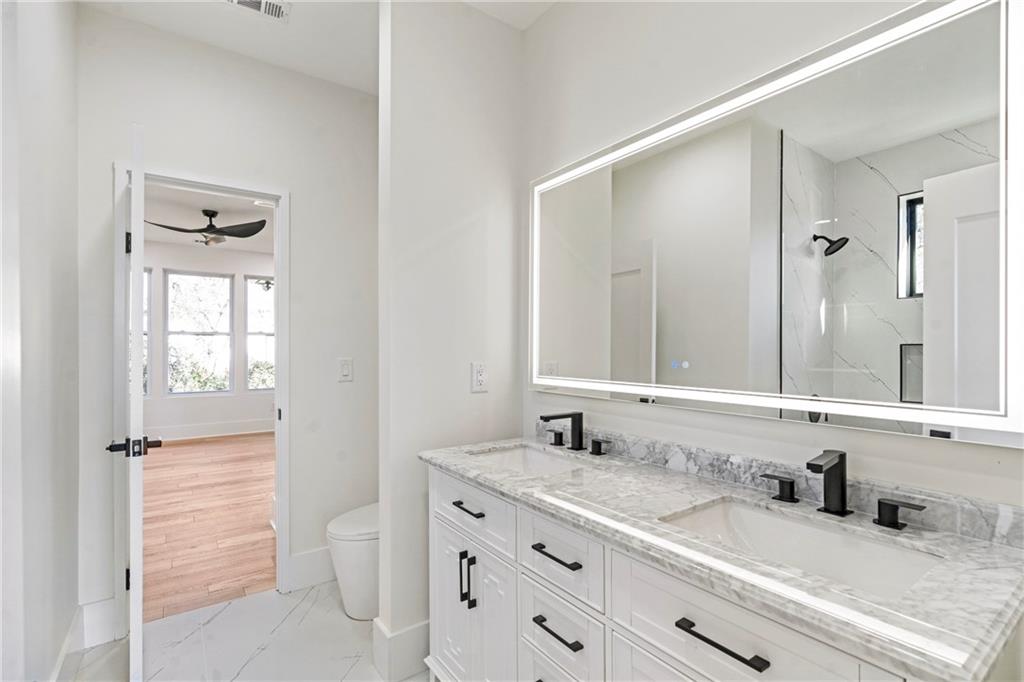 2986 San Jose Drive Decatur, GA 30032 - Photo 31 of 71 a bathroom with a granite countertop sink vanity mirror next to a window