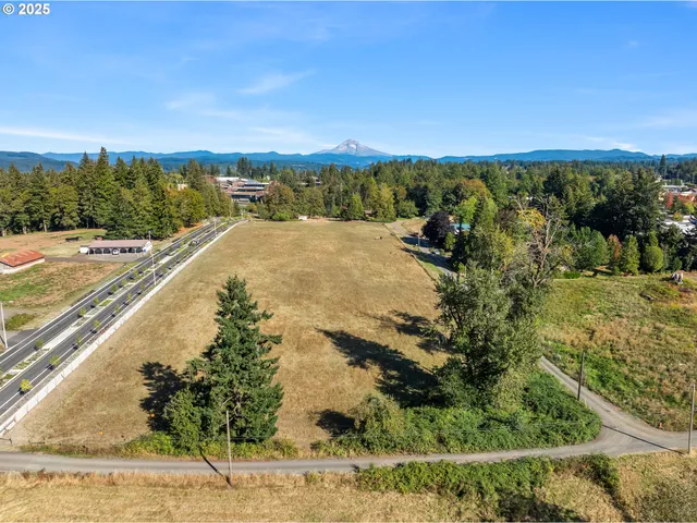 a view of a field with trees in the background