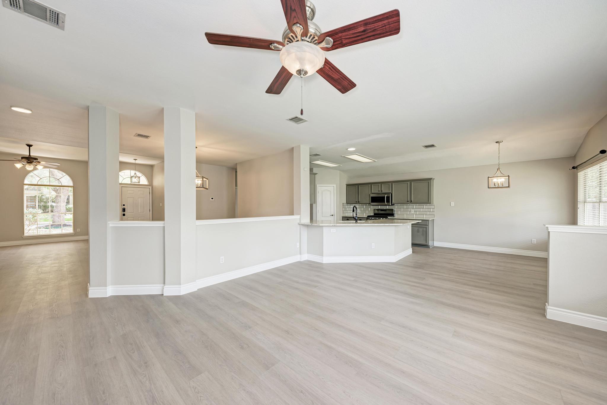 4408 Tello Path Austin, TX 78749 - Photo 11 of 38 Unfurnished living room featuring ceiling fan, healthy amount of natural light, and light wood-style flooring