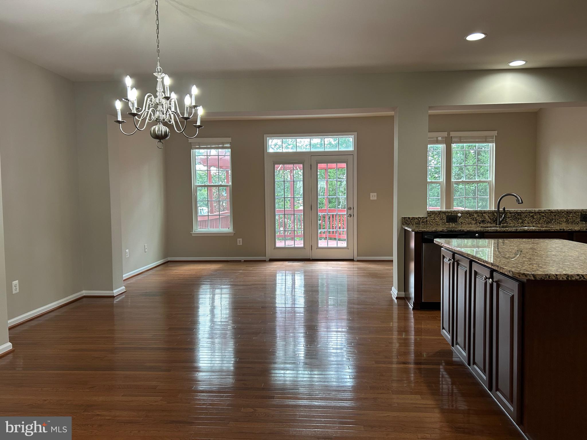 45901 Peach Oak Terrace Sterling, VA 20166 - Photo 3 of 14 a view of a kitchen with granite countertop wooden floor and a chandelier