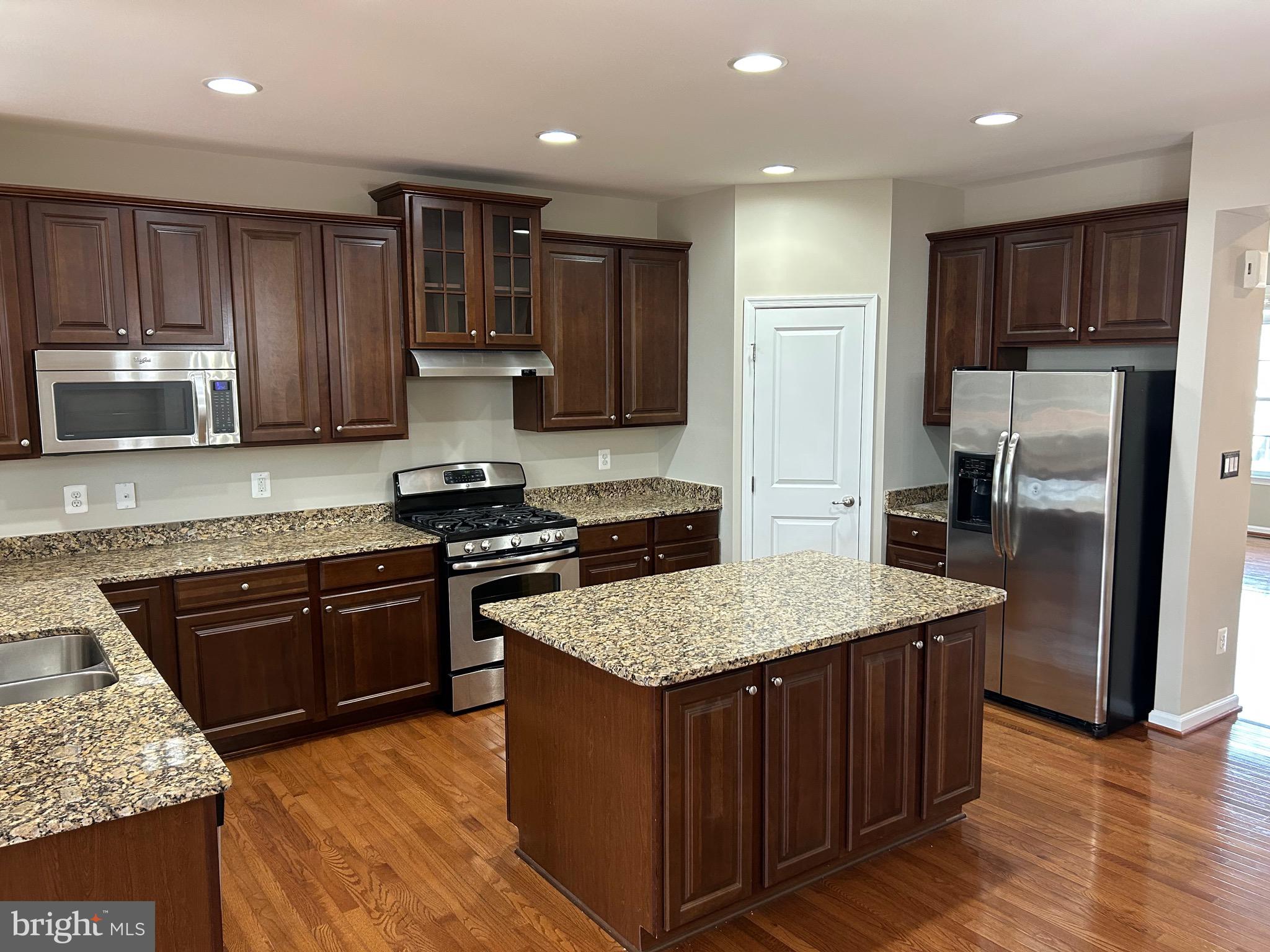 45901 Peach Oak Terrace Sterling, VA 20166 - Photo 4 of 14 a kitchen with stainless steel appliances granite countertop wooden cabinets sink and stove