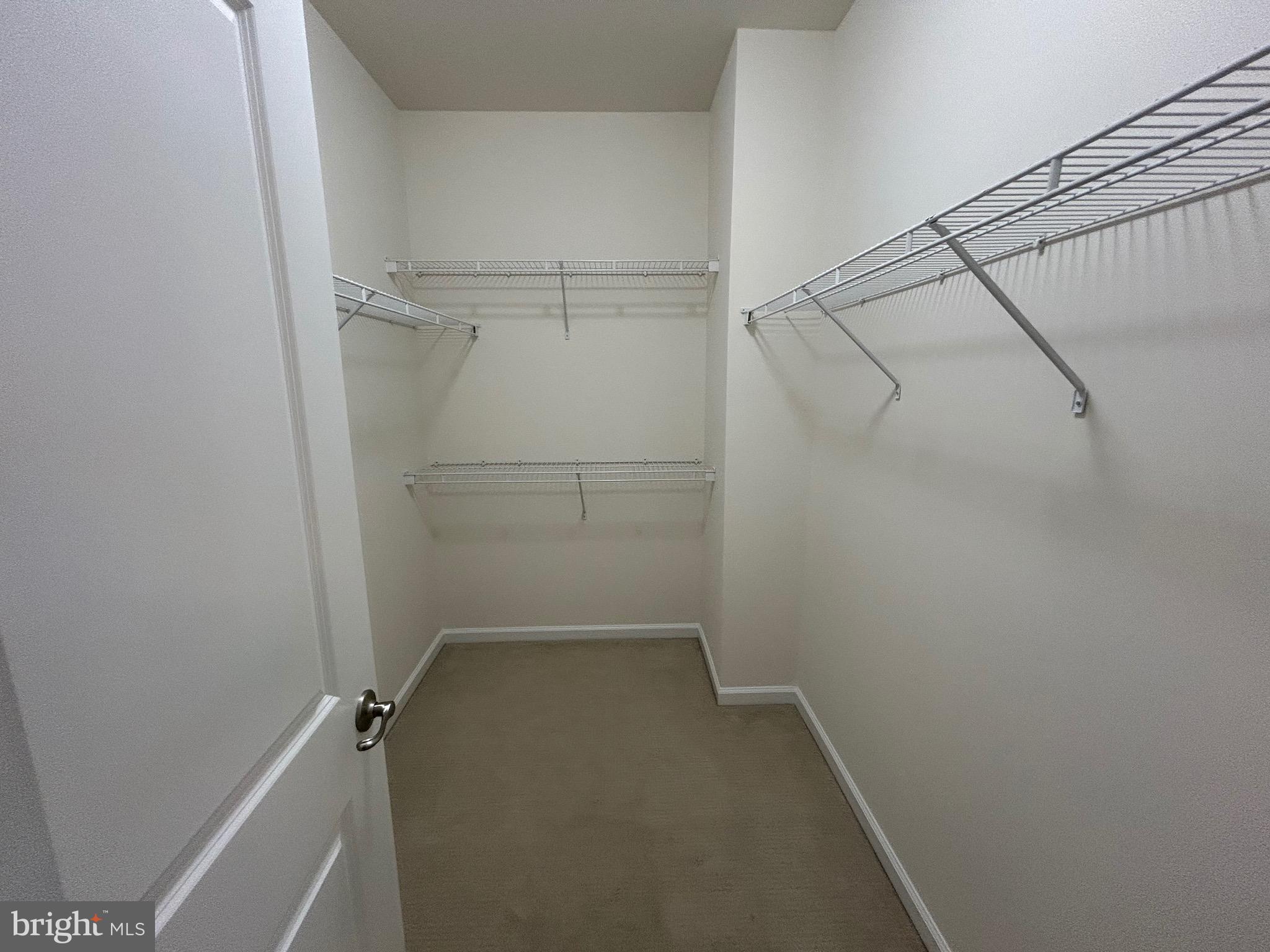 45901 Peach Oak Terrace Sterling, VA 20166 - Photo 9 of 14 a view of a room with racks on the wall