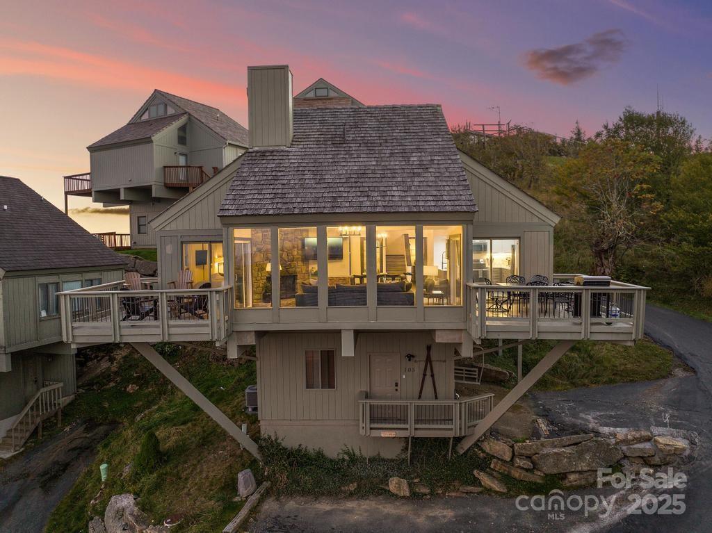 105 Beechtop Road Beech Mountain, NC 28604 - Photo 1 of 42 a front view of a house with balcony