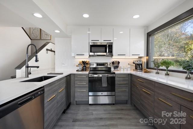 105 Beechtop Road Beech Mountain, NC 28604 - Photo 15 of 42 a kitchen with stainless steel appliances granite countertop a stove a sink and a microwave