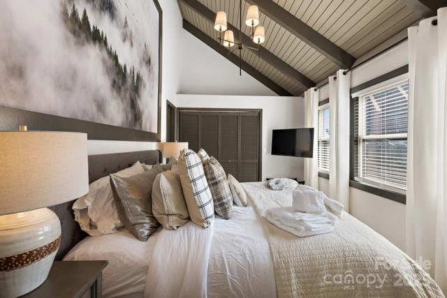 105 Beechtop Road Beech Mountain, NC 28604 - Photo 19 of 42 a bed sitting in a bedroom next to a window with tv