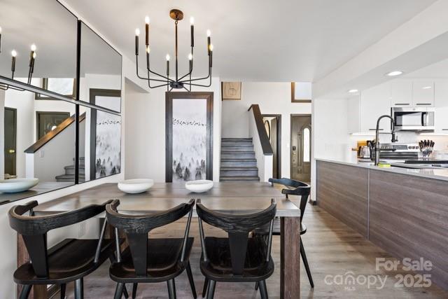 105 Beechtop Road Beech Mountain, NC 28604 - Photo 22 of 42 a view of a dining room with furniture and a chandelier