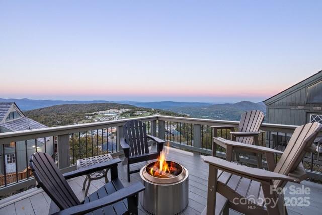 105 Beechtop Road Beech Mountain, NC 28604 - Photo 3 of 42 a view of a balcony with two chairs and a potted plant
