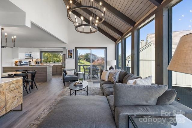 105 Beechtop Road Beech Mountain, NC 28604 - Photo 33 of 42 a living room with furniture fireplace and a large window