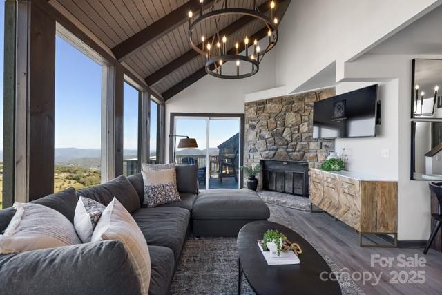 105 Beechtop Road Beech Mountain, NC 28604 - Photo 34 of 42 a living room with furniture a fireplace a flat screen tv and a fireplace