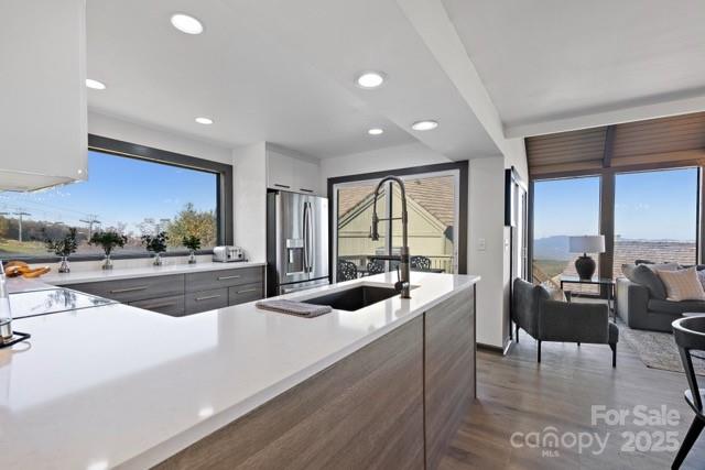 105 Beechtop Road Beech Mountain, NC 28604 - Photo 4 of 42 a large kitchen with stainless steel appliances and a large window