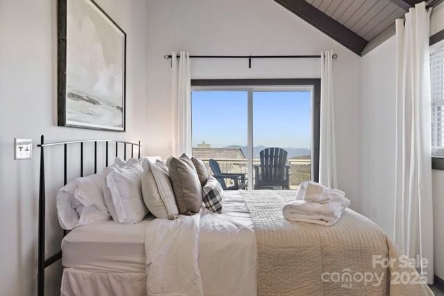 105 Beechtop Road Beech Mountain, NC 28604 - Photo 8 of 42 a bed sitting in a bedroom next to a window