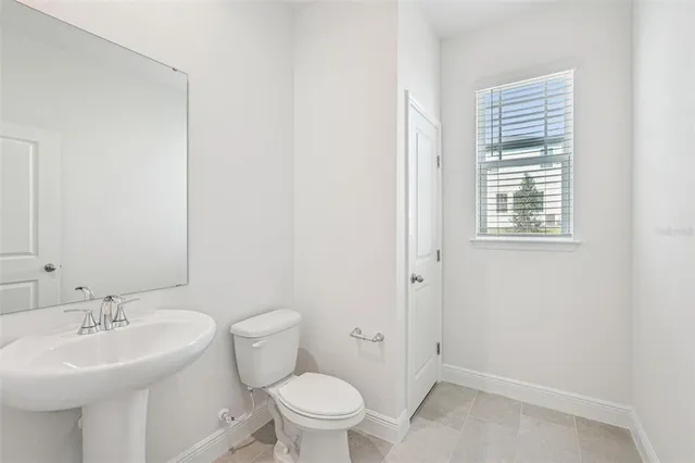 a bathroom with a sink toilet and a mirror