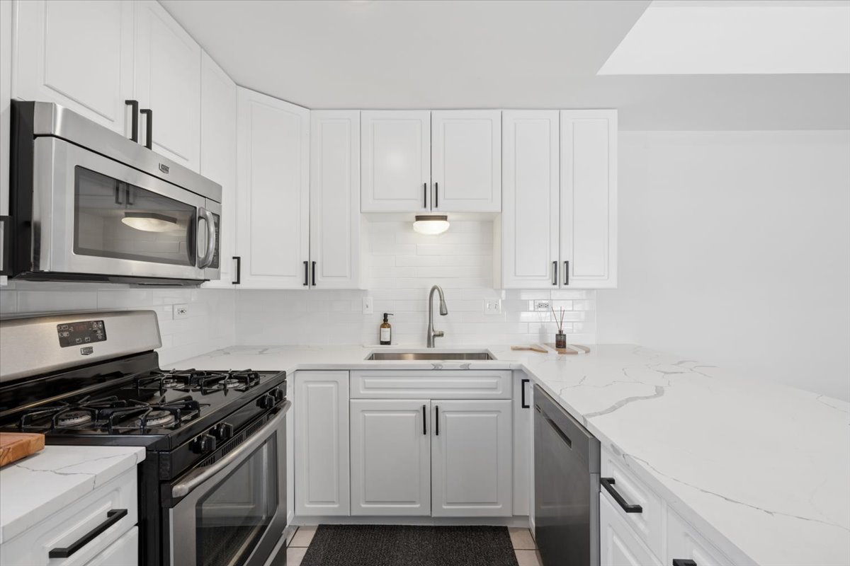 6348 North Magnolia Avenue, Unit 3 Chicago, IL 60660 - Photo 14 of 19 a kitchen with a sink stove and microwave