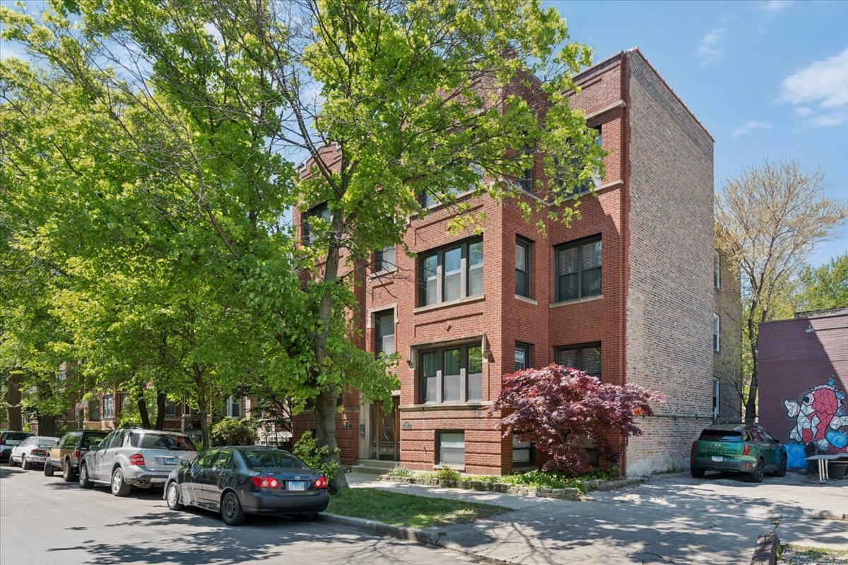 6348 North Magnolia Avenue, Unit 3 Chicago, IL 60660 - Photo 2 of 19 a car parked in front of a brick house