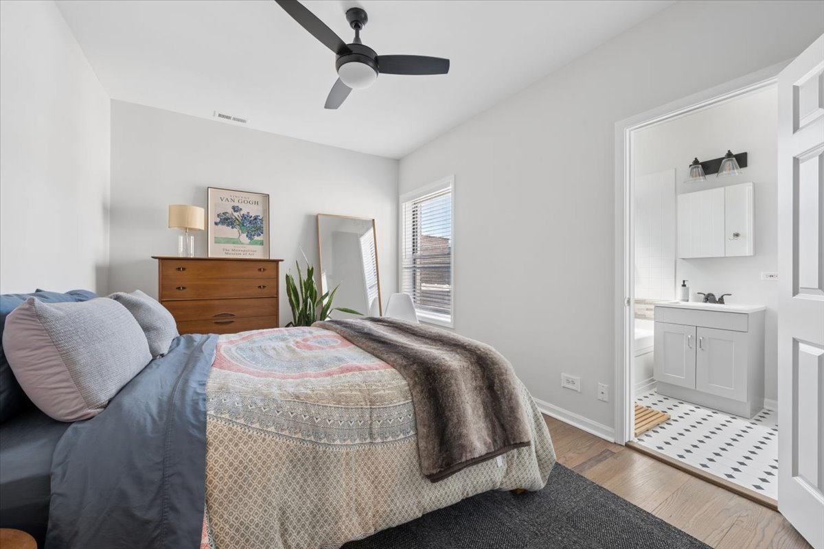 6348 North Magnolia Avenue, Unit 3 Chicago, IL 60660 - Photo 7 of 19 a bedroom with a bed and a cabinets