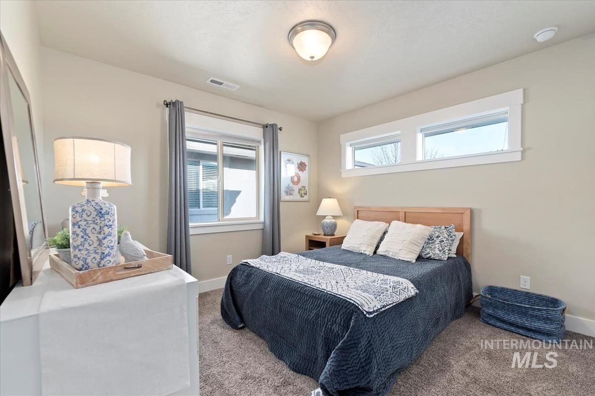 8014 South Bogus Ridge Way Boise, ID 83716 - Photo 18 of 44 Bedroom featuring carpet flooring and multiple windows