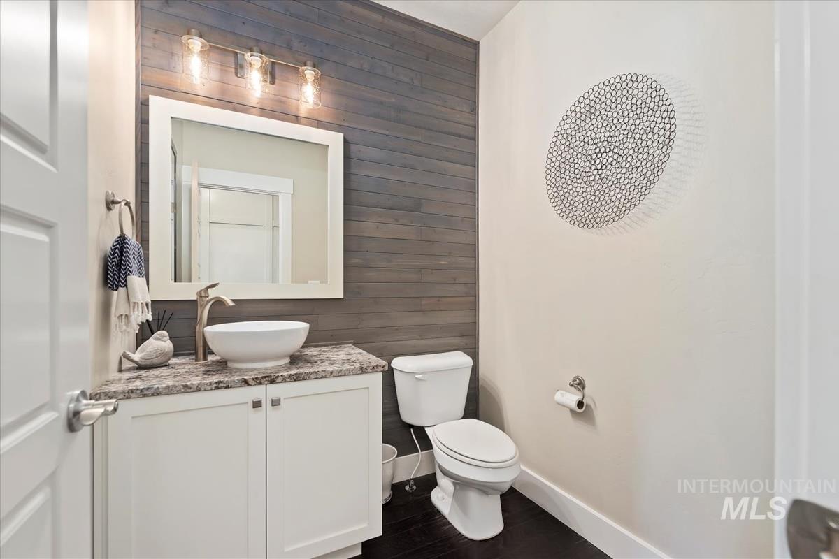 8014 South Bogus Ridge Way Boise, ID 83716 - Photo 28 of 44 Bathroom featuring wood walls, vanity, and dark wood-style flooring