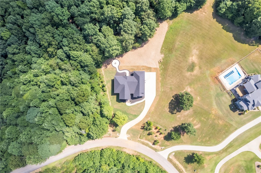 574 Paramount Drive Seneca, SC 29678 - Photo 40 of 45 An aerial perspective showcases a secluded estate nestled among verdant woods with an inviting pool nearby.