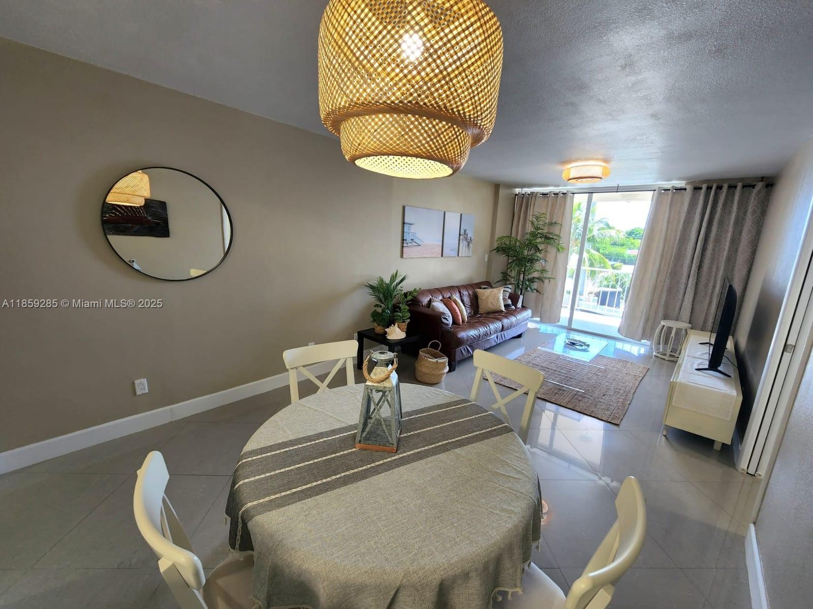 88500 Overseas Highway, Unit 301 Islamorada, FL 33036 - Photo 12 of 24 a dining room with furniture and a window