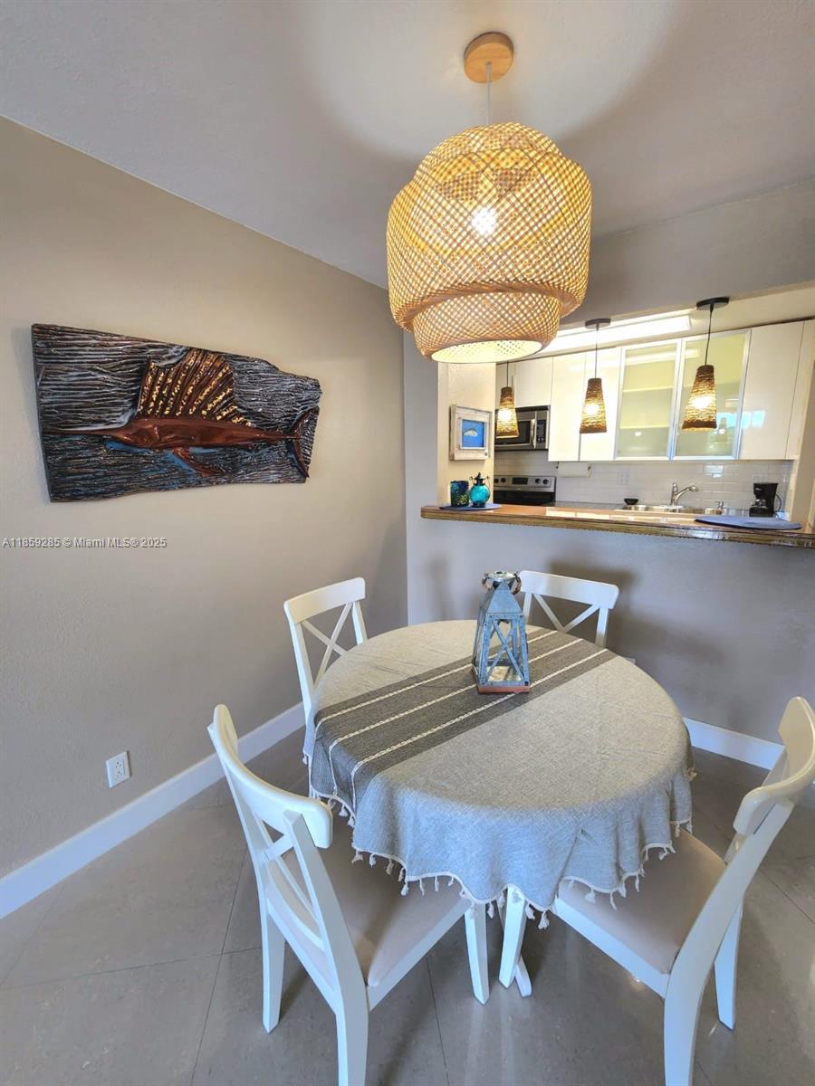 88500 Overseas Highway, Unit 301 Islamorada, FL 33036 - Photo 13 of 24 a view of a dining room with furniture and a large window
