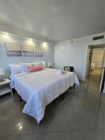 a bedroom with bed and window