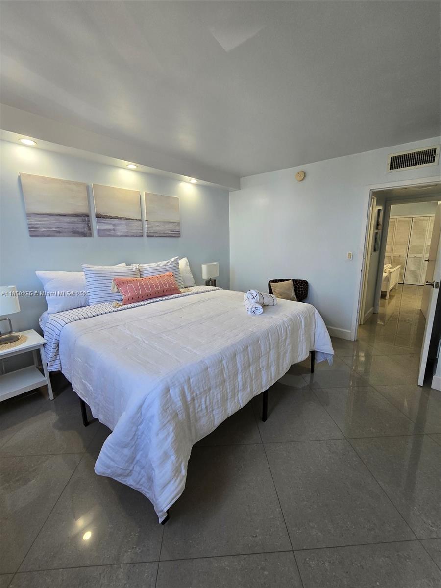 88500 Overseas Highway, Unit 301 Islamorada, FL 33036 - Photo 18 of 24 a bedroom with bed and window