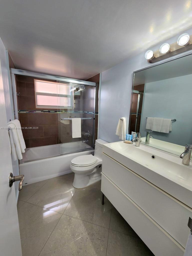 88500 Overseas Highway, Unit 301 Islamorada, FL 33036 - Photo 20 of 24 a bathroom with a toilet sink and mirror