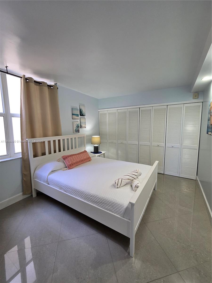 88500 Overseas Highway, Unit 301 Islamorada, FL 33036 - Photo 23 of 24 a bedroom with a bed and a window