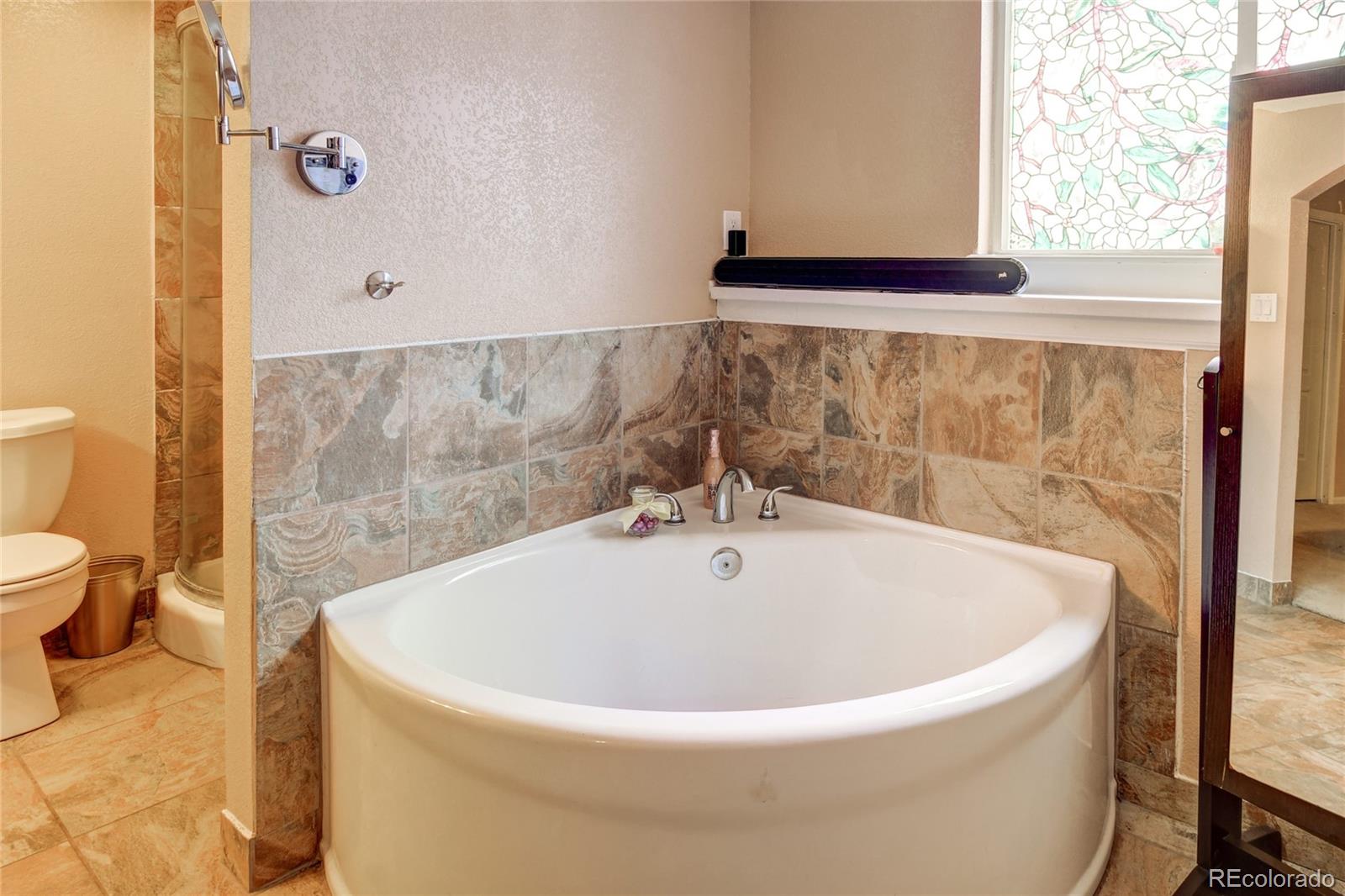 820 South Denver Avenue Fort Lupton, CO 80621 - Photo 11 of 40 a white bath tub sitting next to a white sink