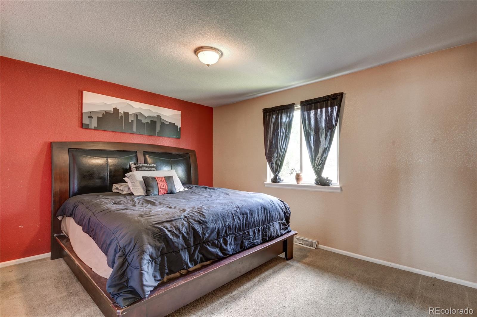 820 South Denver Avenue Fort Lupton, CO 80621 - Photo 15 of 40 a bedroom with a bed and window