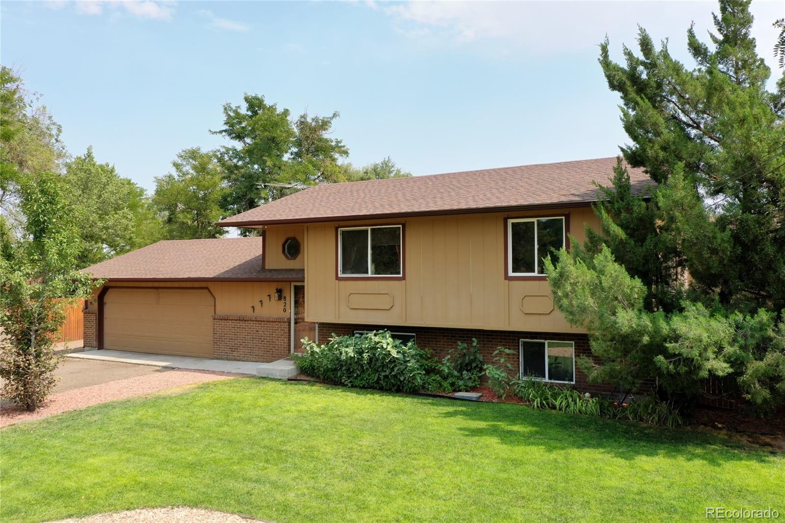 820 South Denver Avenue Fort Lupton, CO 80621 - Photo 28 of 40 a front view of a house with a garden