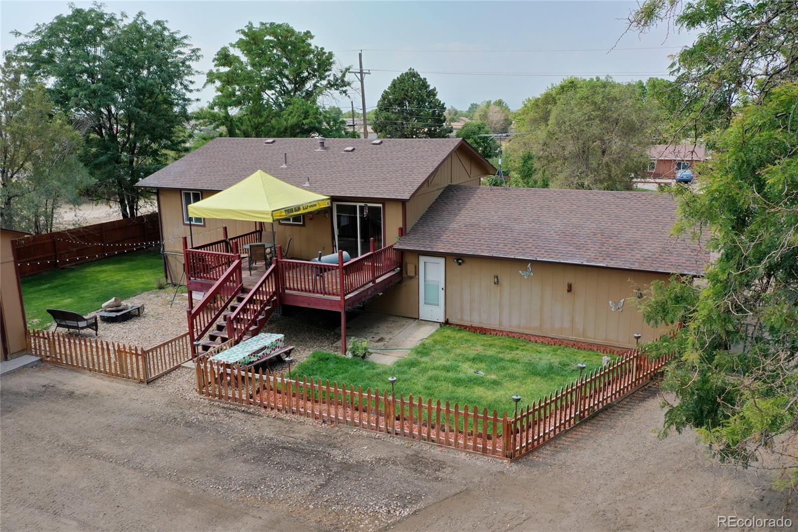 820 South Denver Avenue Fort Lupton, CO 80621 - Photo 31 of 40 an aerial view of a house with garden space and street view