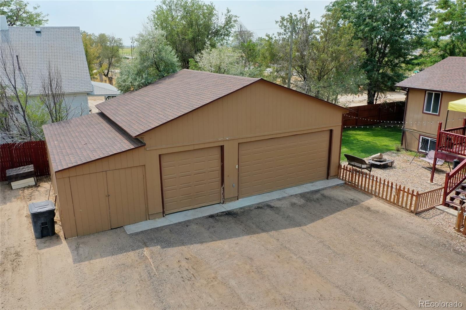 820 South Denver Avenue Fort Lupton, CO 80621 - Photo 32 of 40 a view of a house with a backyard and sitting area