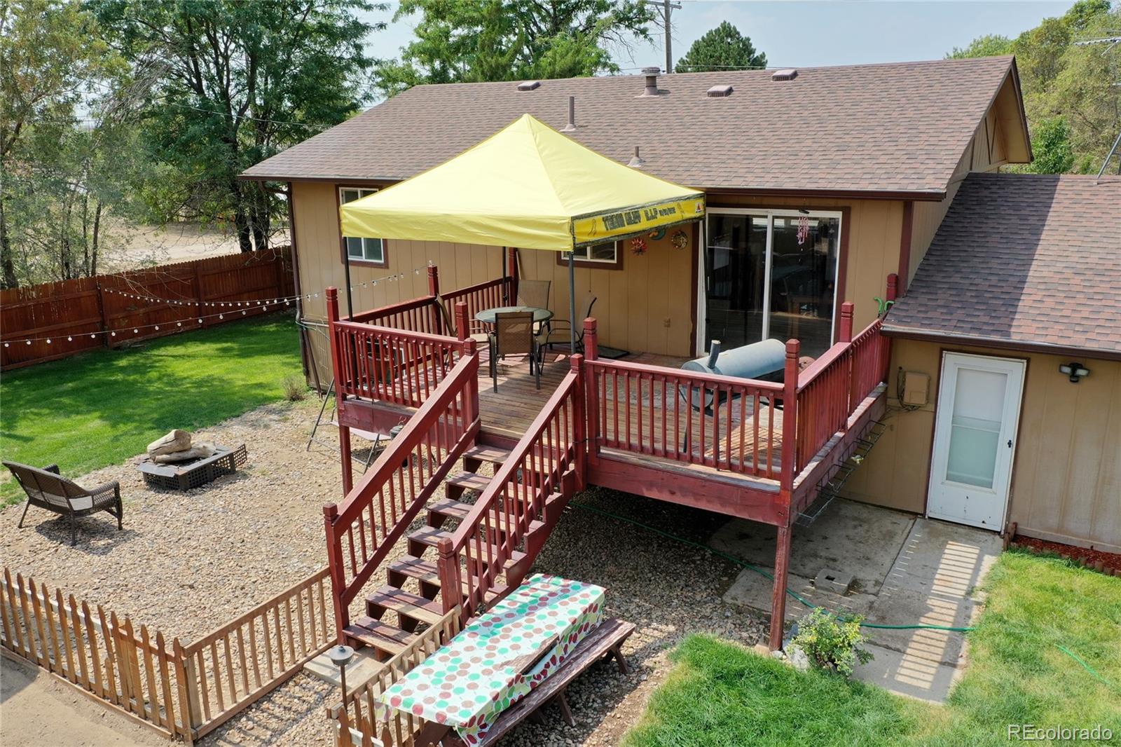 820 South Denver Avenue Fort Lupton, CO 80621 - Photo 35 of 40 a view of a chair and table in backyard