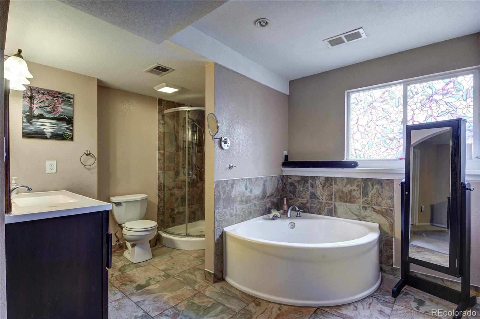 820 South Denver Avenue Fort Lupton, CO 80621 - Photo 8 of 40 a bathroom with a bathtub and sink
