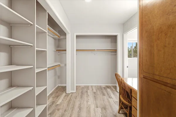 a view of a room with wooden floor and staircase