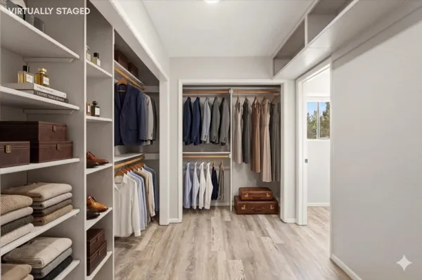 a view of a room with wooden floor and entryway