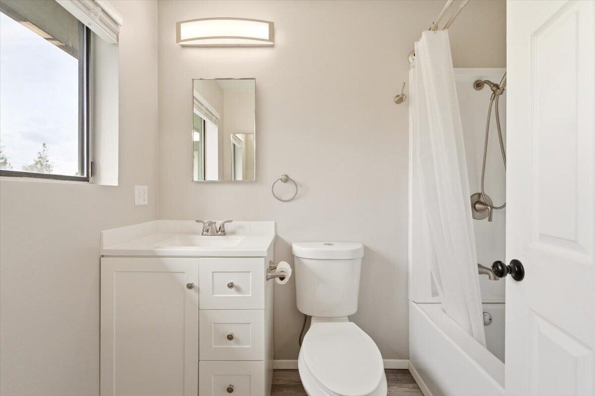 15617 Sherwood Road Weed, CA 96094 - Photo 16 of 58 a bathroom with a toilet a sink a mirror a window and vanity
