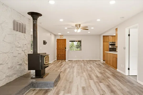 a view of an empty room with a window and a ceiling fan