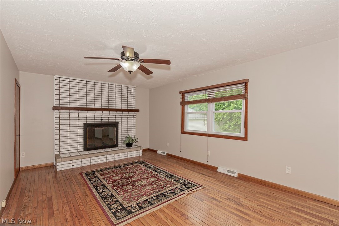 5523 Huron Road Lyndhurst, OH 44124 - Photo 14 of 34 The family room featuring wood burning fireplace, natural light and newer vinyl windows.